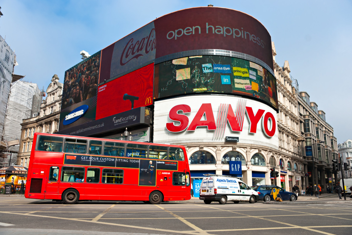 Piccadilly Circus in London, England, with a double decker bus and famous advertisements
