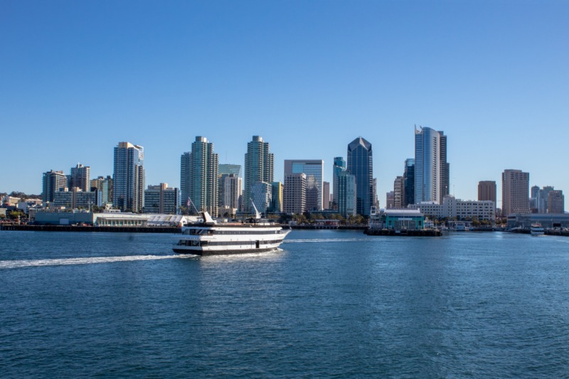 A whale watching boat in San Diego Bay with the San Diego skyline in the distance